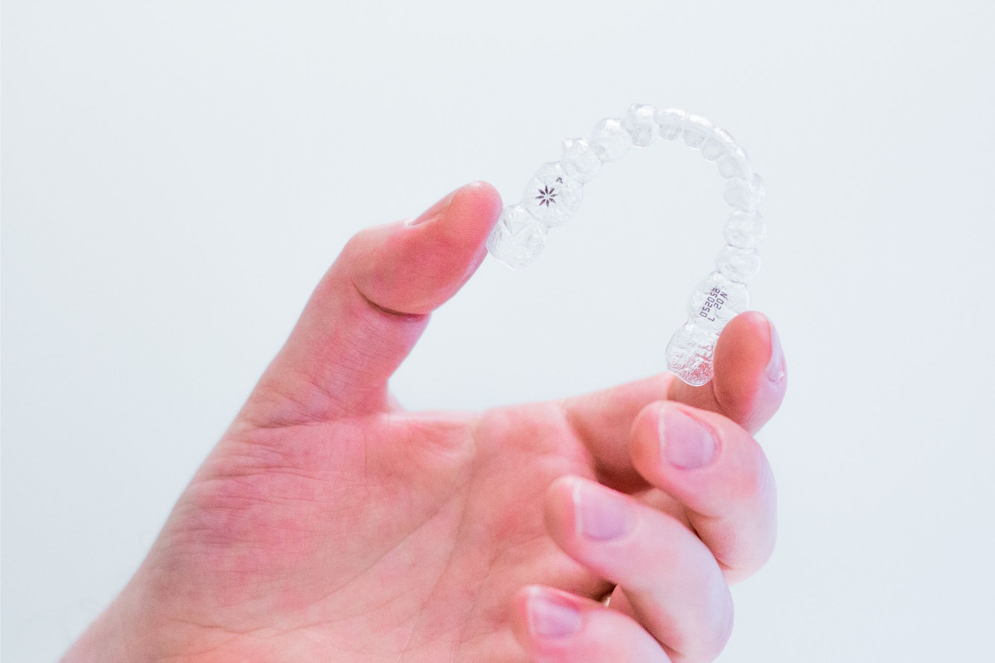 hand-holding-invisalign-aligners Invisalign aligners