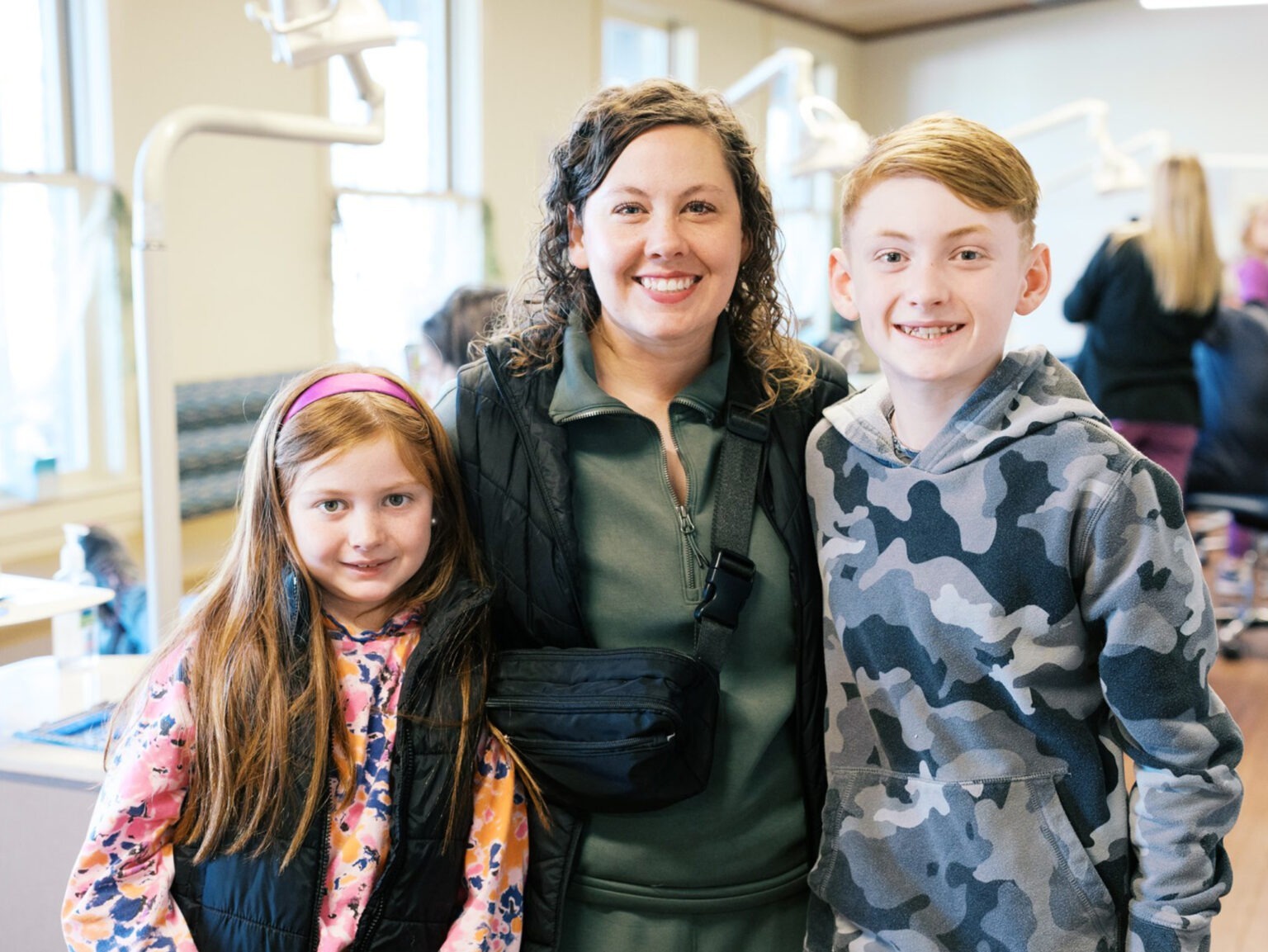 Happy family smiling together at the Designer Smiles by Benton orthodontics office in Oxford, AL